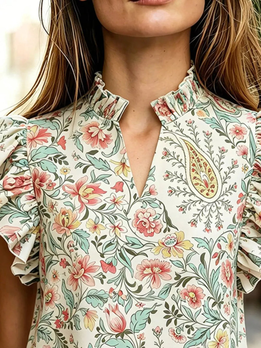Cream floral print t-shirt with ruffled mock neck and flutter sleeves.