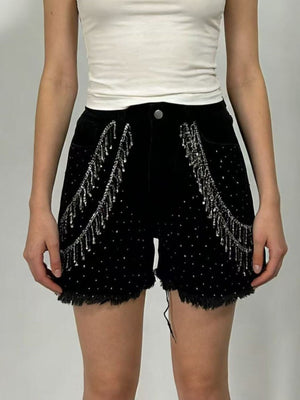 Black denim shorts with rhinestone embellishments and chain fringe detail.