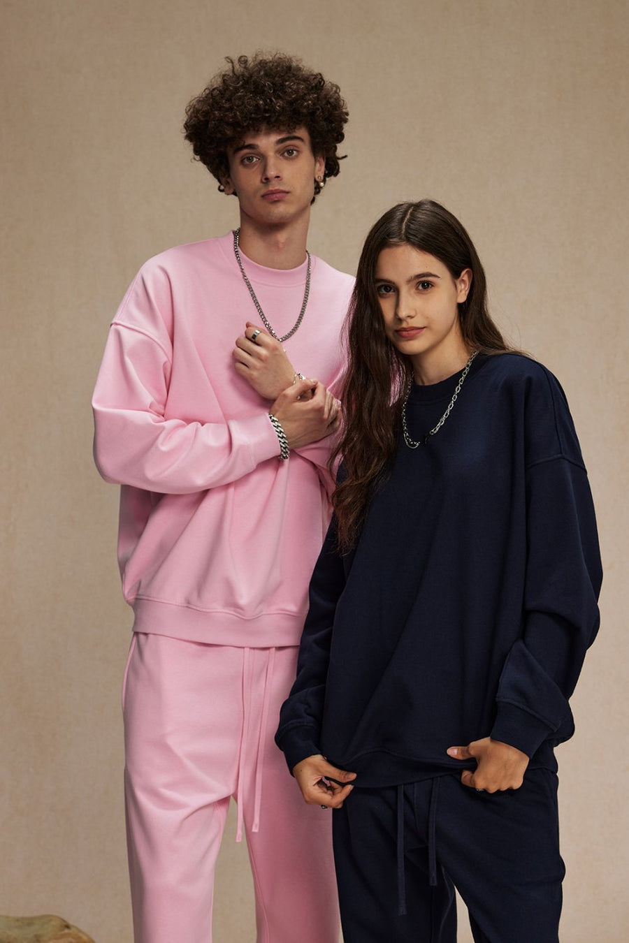 Pink crewneck sweatshirt with long sleeves and matching sweatpants