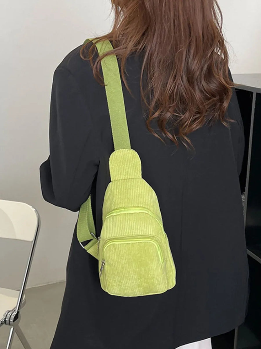 Yellow Green corduroy sling bag with zip pockets worn crossbody