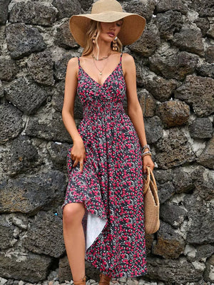 Midi dress with floral print, v-neck, spaghetti straps, smocked bodice, and asymmetrical hem.