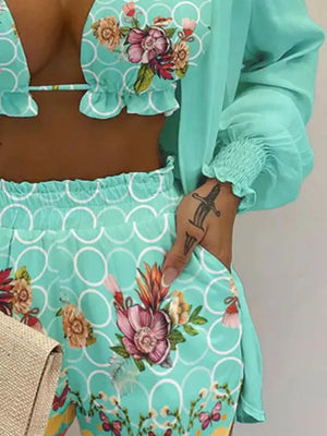 Mint blue floral print two-piece outfit set with ruffled trim and smocked sleeves.