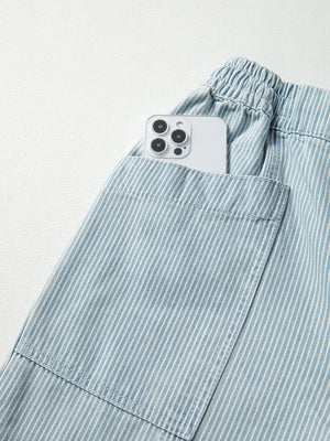 Light blue pinstripe drawstring jeans with a phone in the pocket.