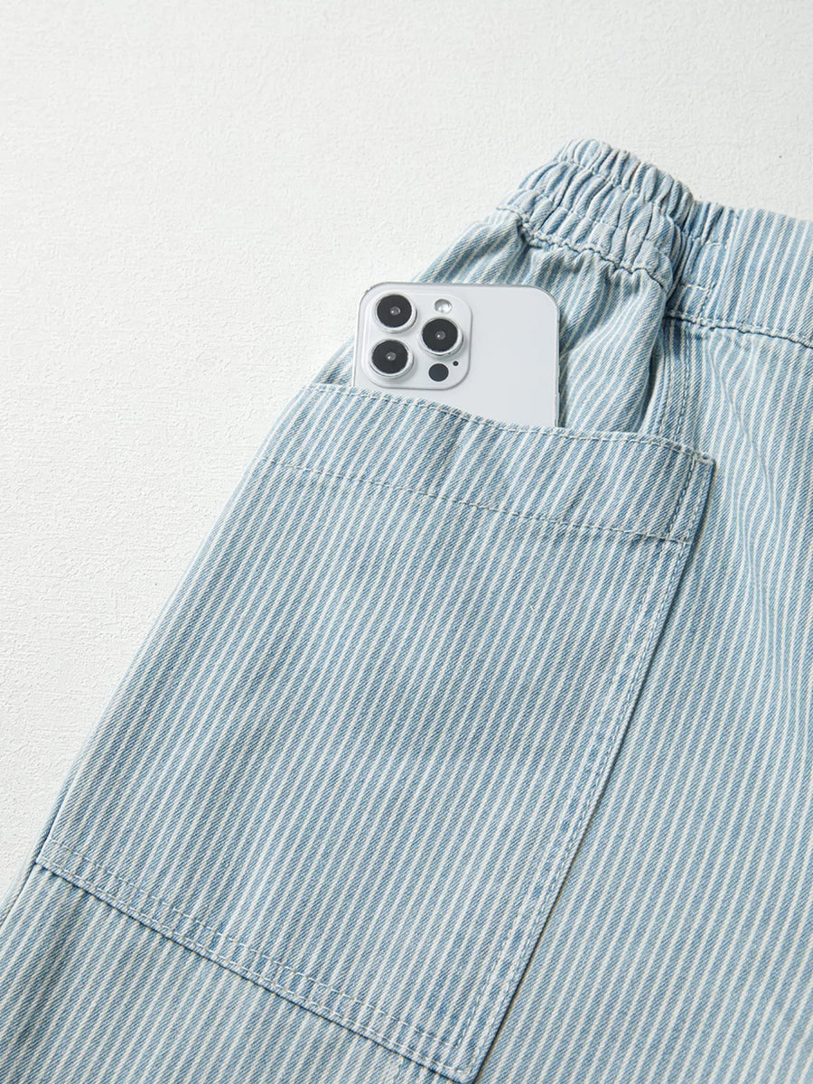 Light blue pinstripe drawstring jeans with a phone in the pocket.
