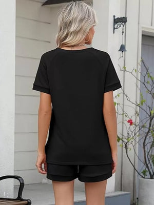 Black relaxed two-piece set with drawstring shorts and short sleeve top.