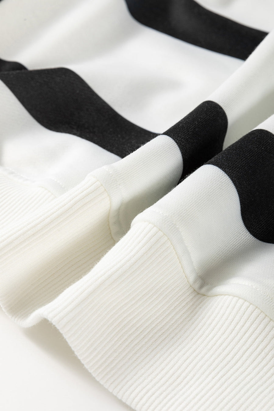 Black and white striped loungewear set with ribbed cuffs and hem detail.