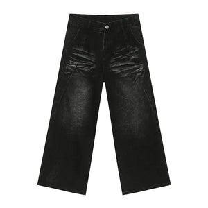 Faded black denim palazzo trousers with a wide leg and distressed detailing.