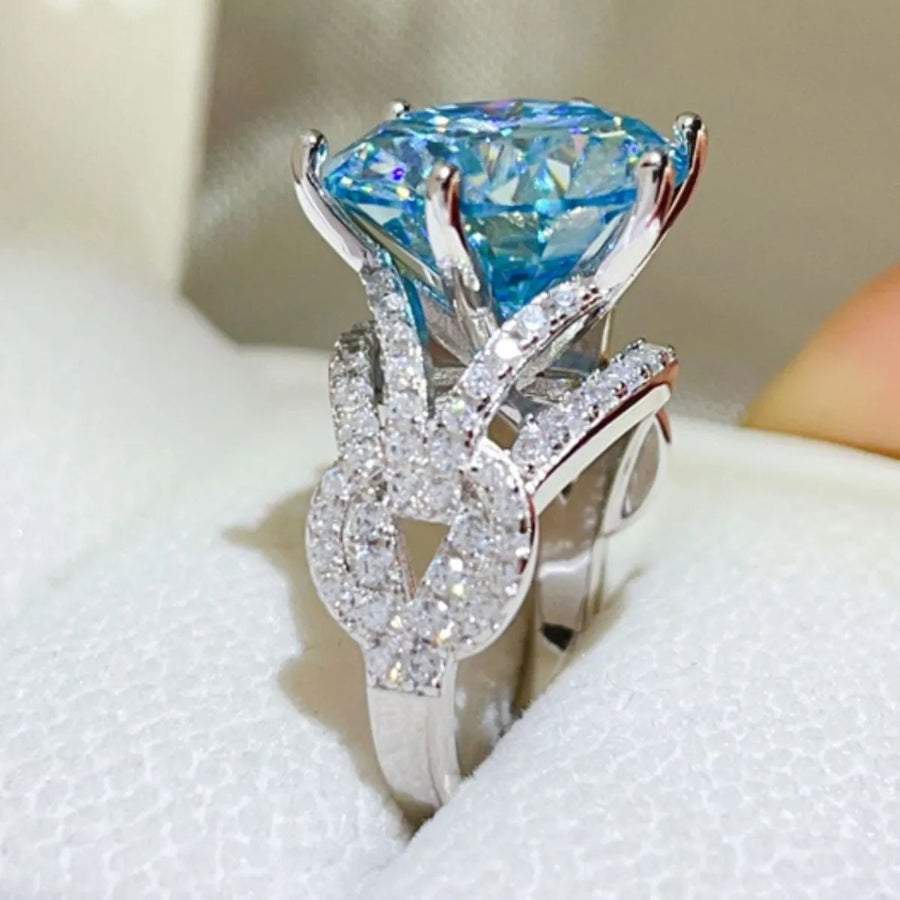 Celestial blue moissanite knot ring with pave diamond accents.