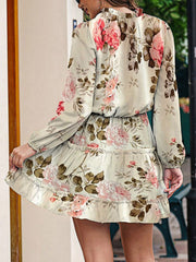 Ivory floral print tiered mini dress with ruffled hem and long sleeves.
