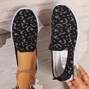 Black celestial knit slip-on sneakers with moon and star pattern
