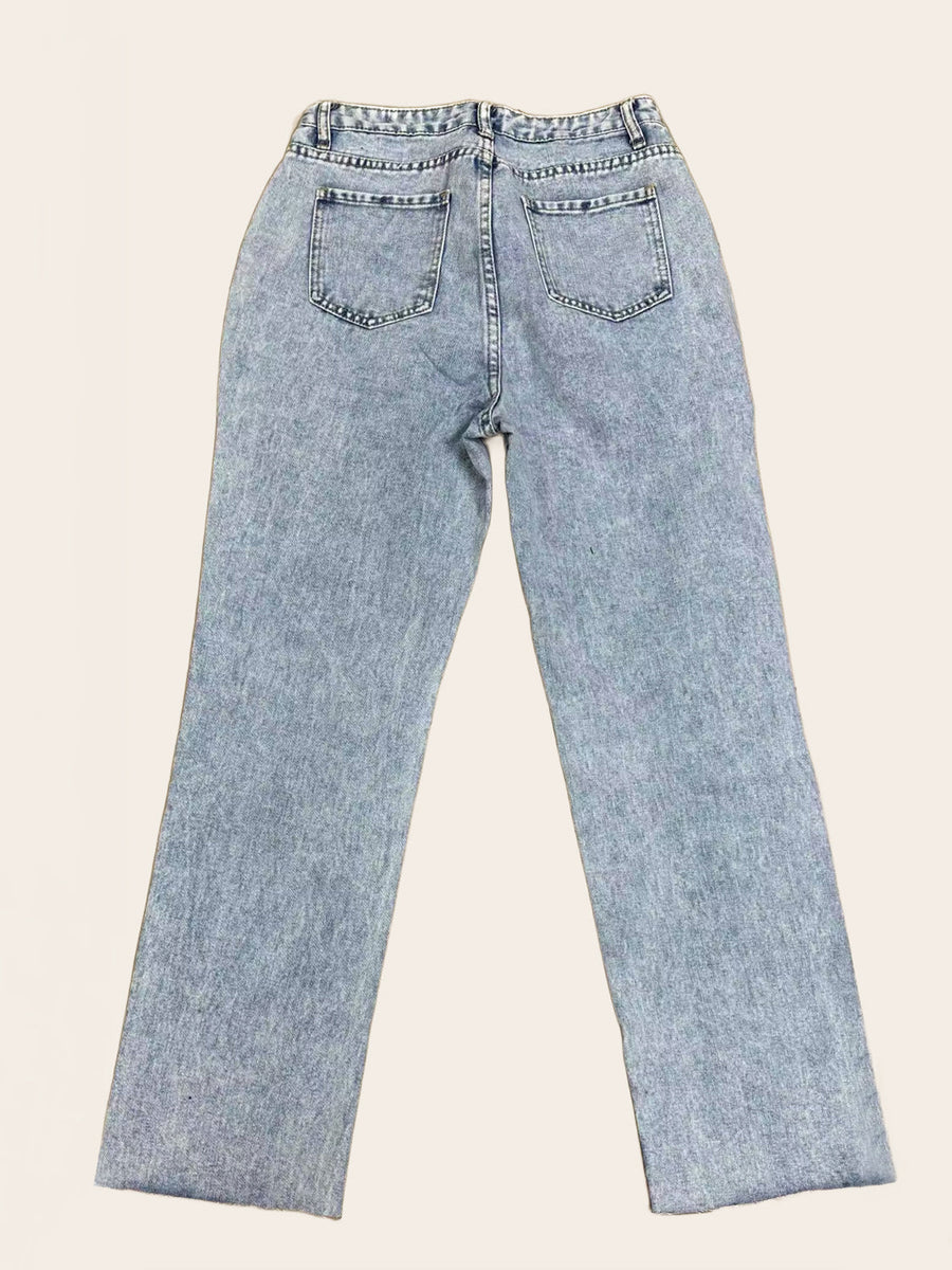 Light wash denim wide leg jeans with distressed knee rips and button fly.