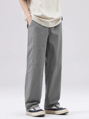 Men's grey casual wide-leg sweatpants with visible stitching details.