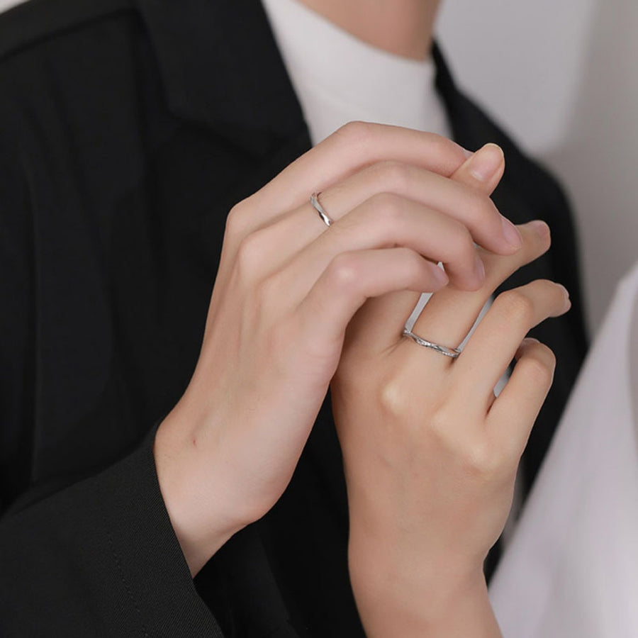 Adjustable sterling silver rings with zircon detail, Style A and Style B, worn by a couple.