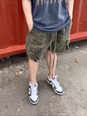 Camo cargo shorts with raw hem and drawstring, green camouflage pattern.