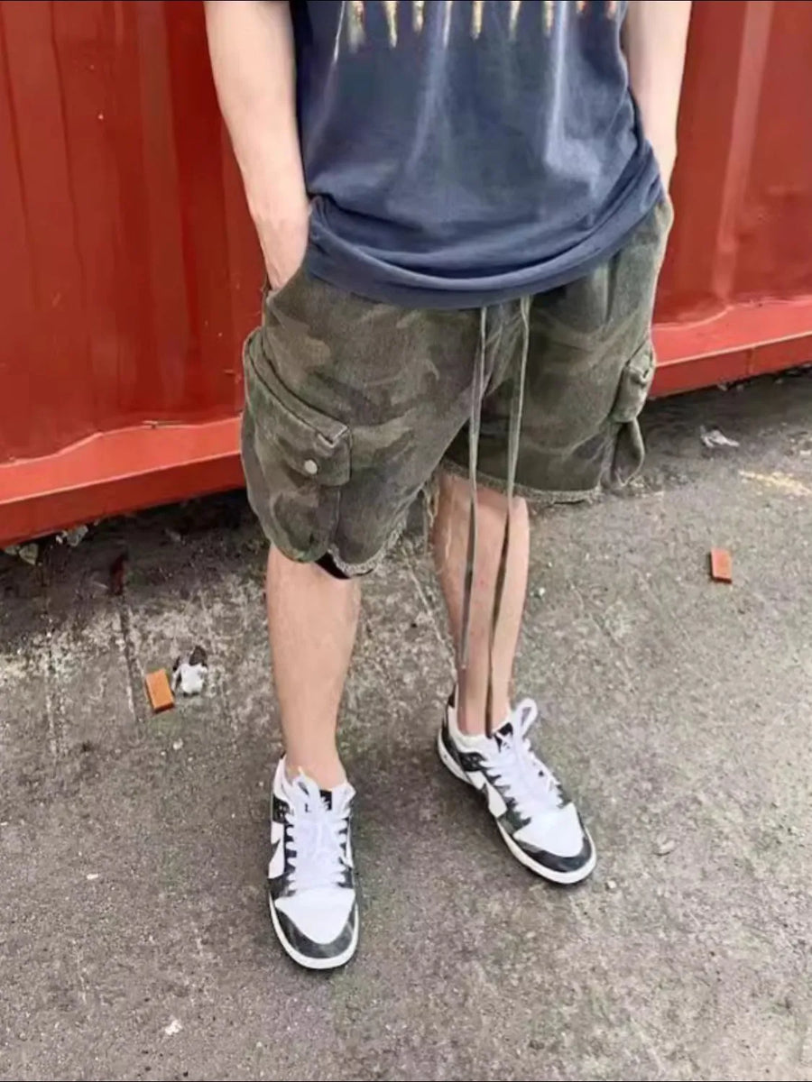 Camo cargo shorts with raw hem and drawstring, green camouflage pattern.