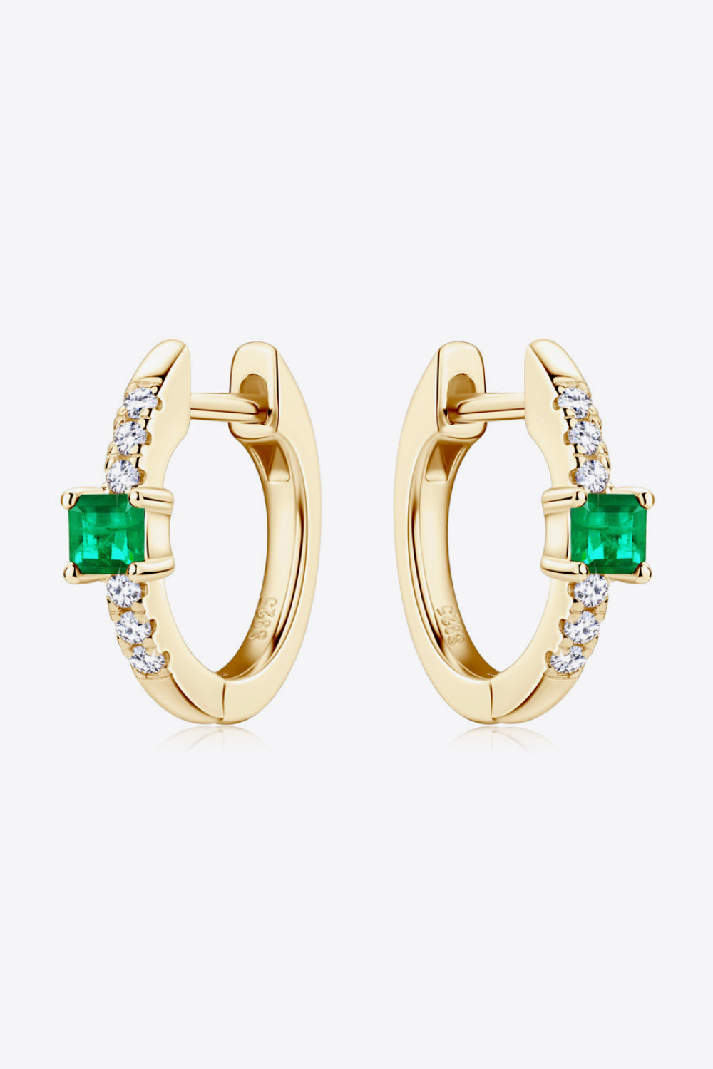 Gold huggie hoop earrings with emerald square and pave diamond details.