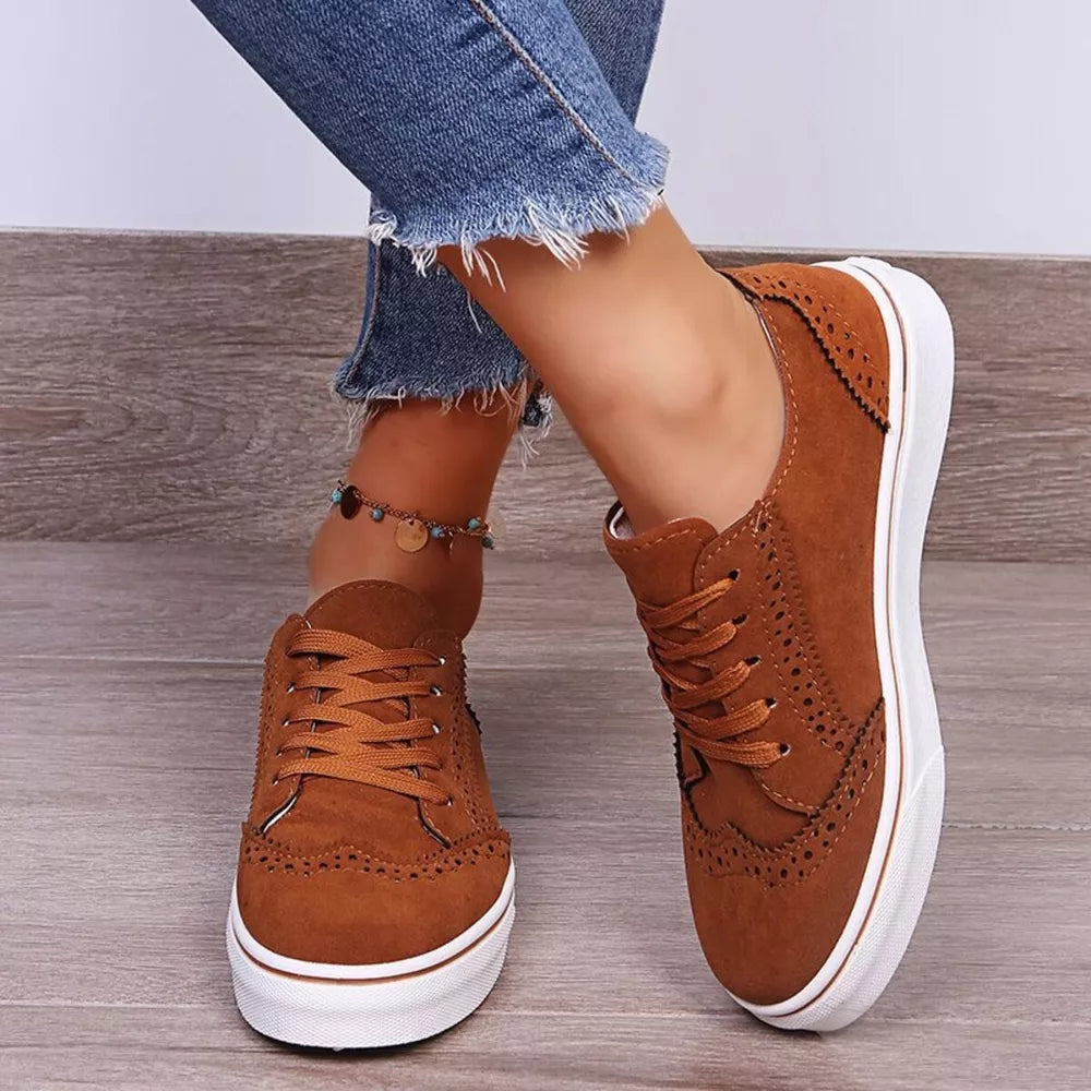 Brown matte finish lace-up sneakers with brogue detailing and white soles.