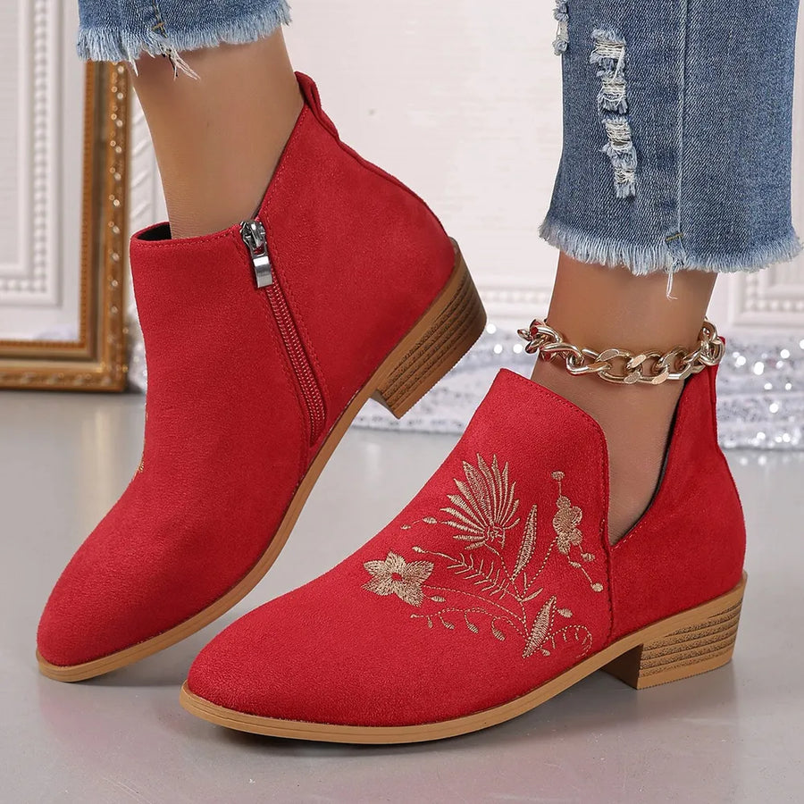 Red suede ankle boots with gold floral embroidery and side zip.