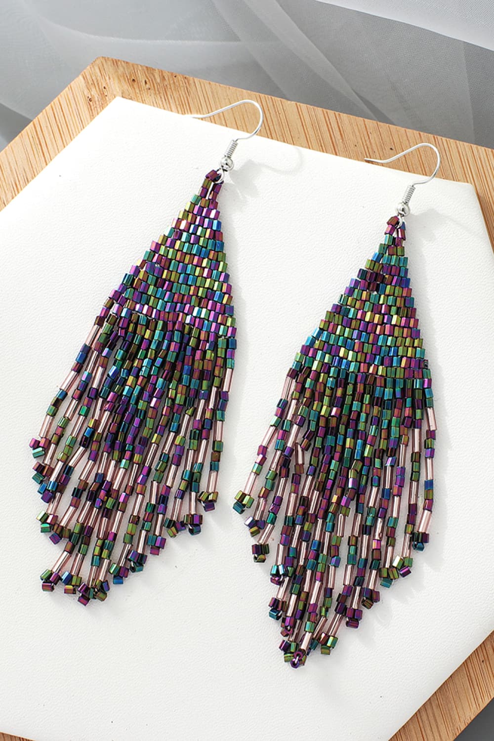 Prismatic beaded fringe earrings with multicolor beads and dangling strands.