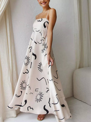 Artistic spaghetti strap maxi dress in ivory with black abstract print and square neckline.
