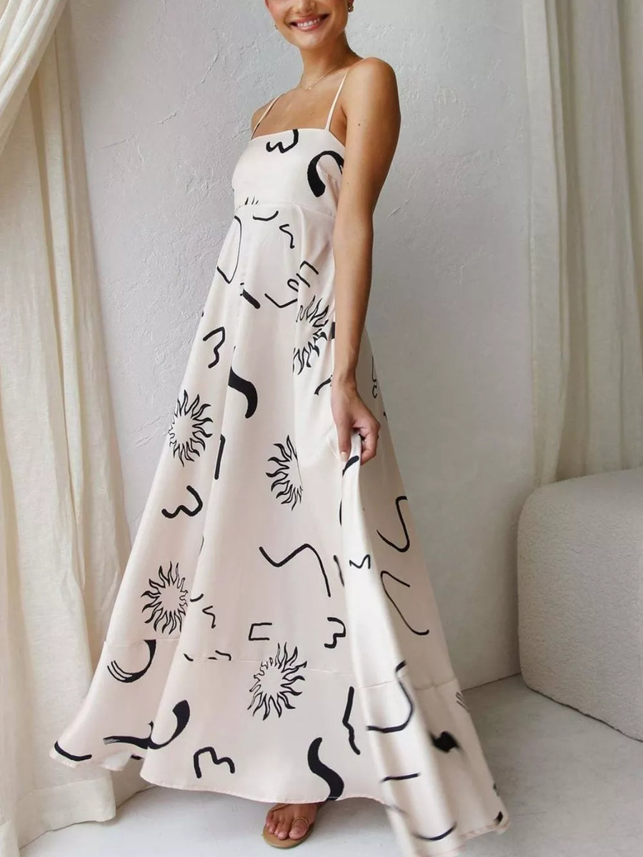 Artistic spaghetti strap maxi dress in ivory with black abstract print and square neckline.