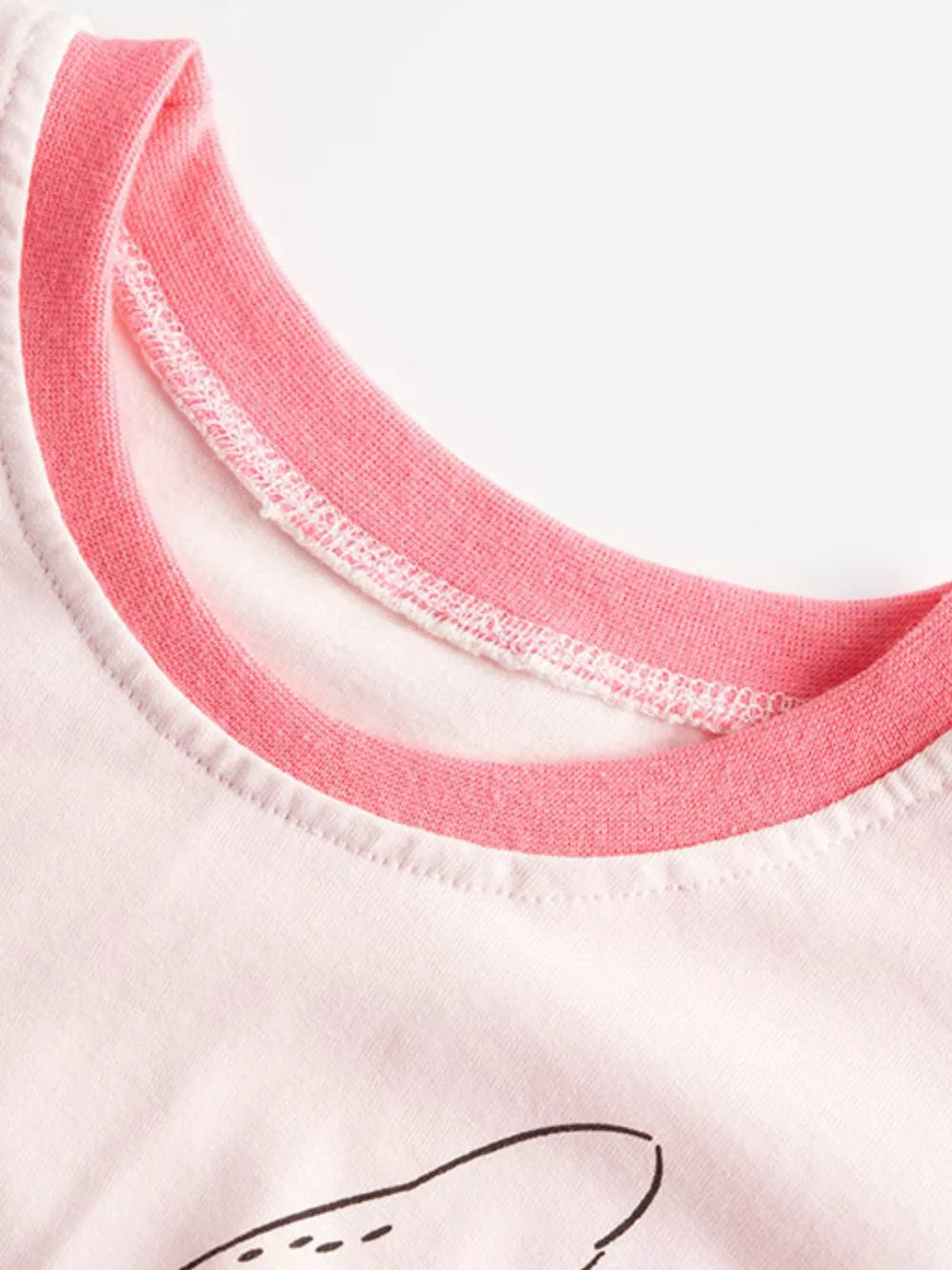 White t-shirt with pink trim neckline and a graphic detail.