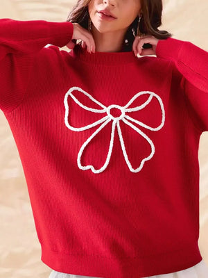 Red ribbed sweater with white bow detail and mock neckline.