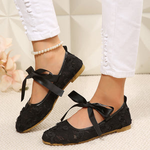 black shoes featuring bow detail and floral