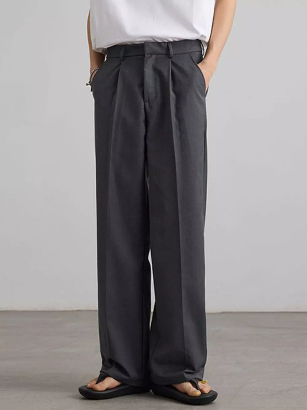 Grey pleated wide-leg trousers with a relaxed fit and casual styling.