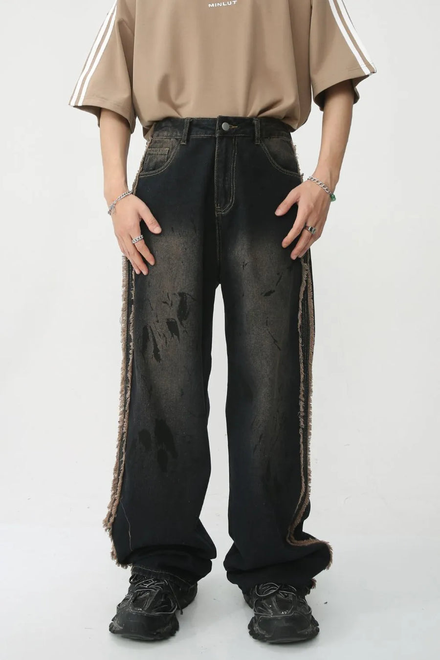 Distressed wide-leg jeans in dark wash denim with frayed trim and a relaxed fit.