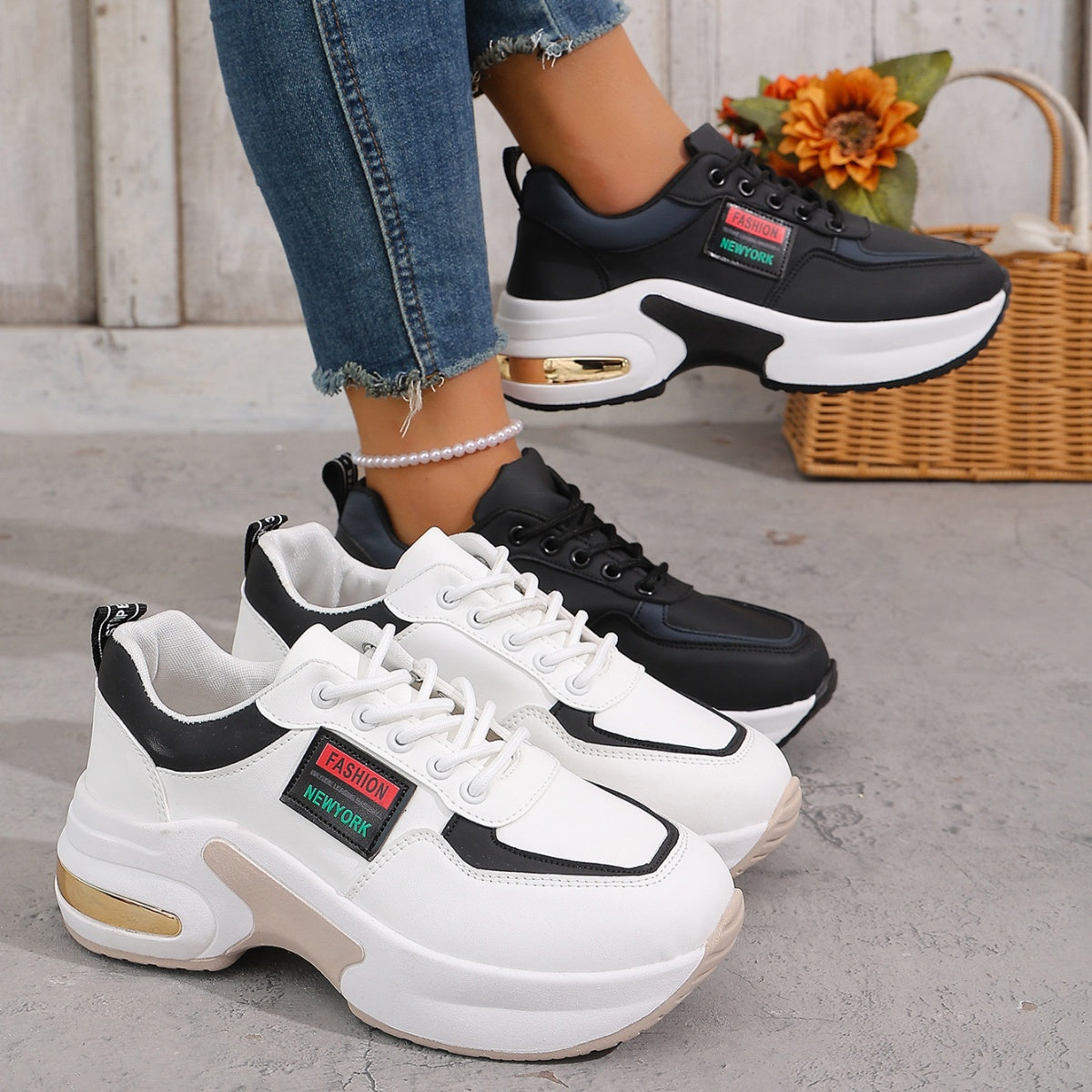 Trendy round toe lace-up sneakers in gray/white and black with chunky soles and gold accents.