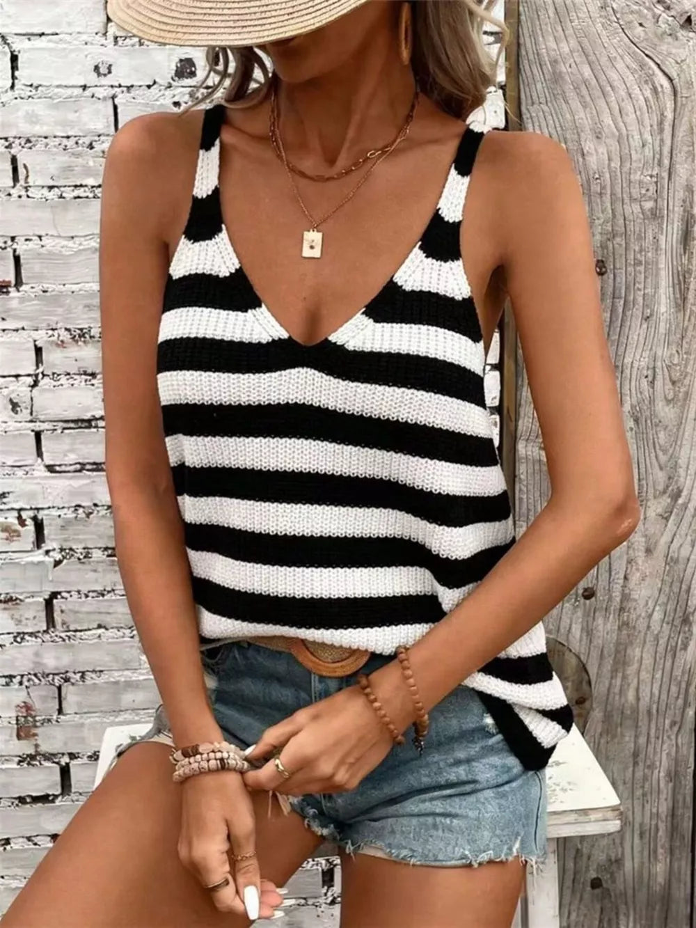 Relaxed black and white striped V-neck knit tank top with a relaxed fit.