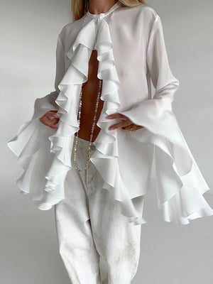 White ruffled flounce sleeve blouse with a buttoned neckline and airy fabric.