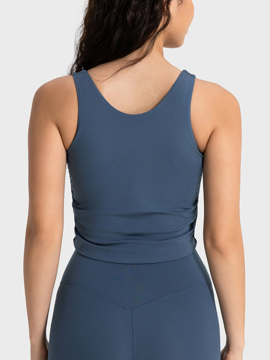 Sculpted ruched tank top in peacock blue with a scoop neck and athletic fit.