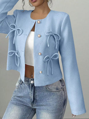 Light blue textured jacket with tie details and pearl buttons