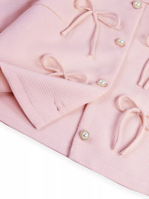 Pink textured jacket with pearl buttons and tie details