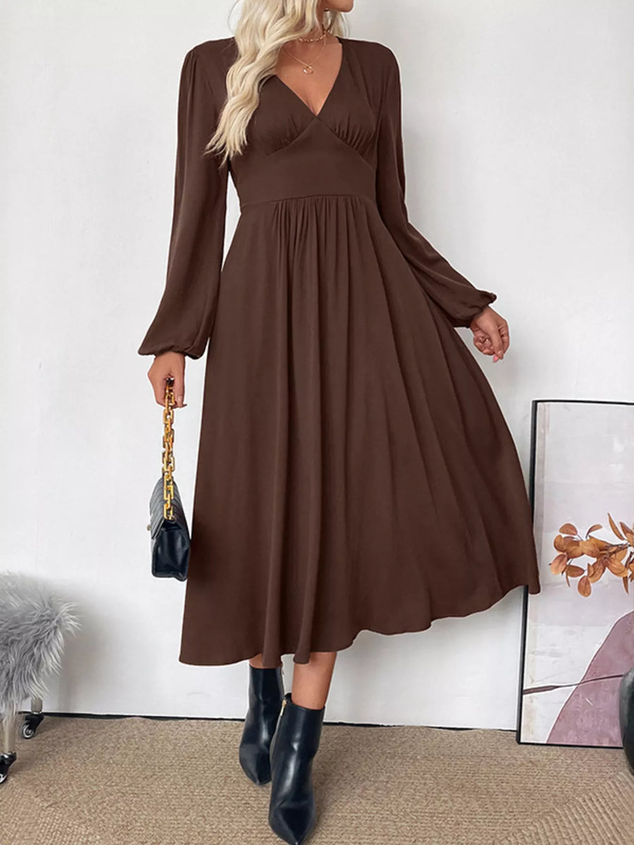 Brown V-neck midi dress with puff sleeves and A-line skirt.