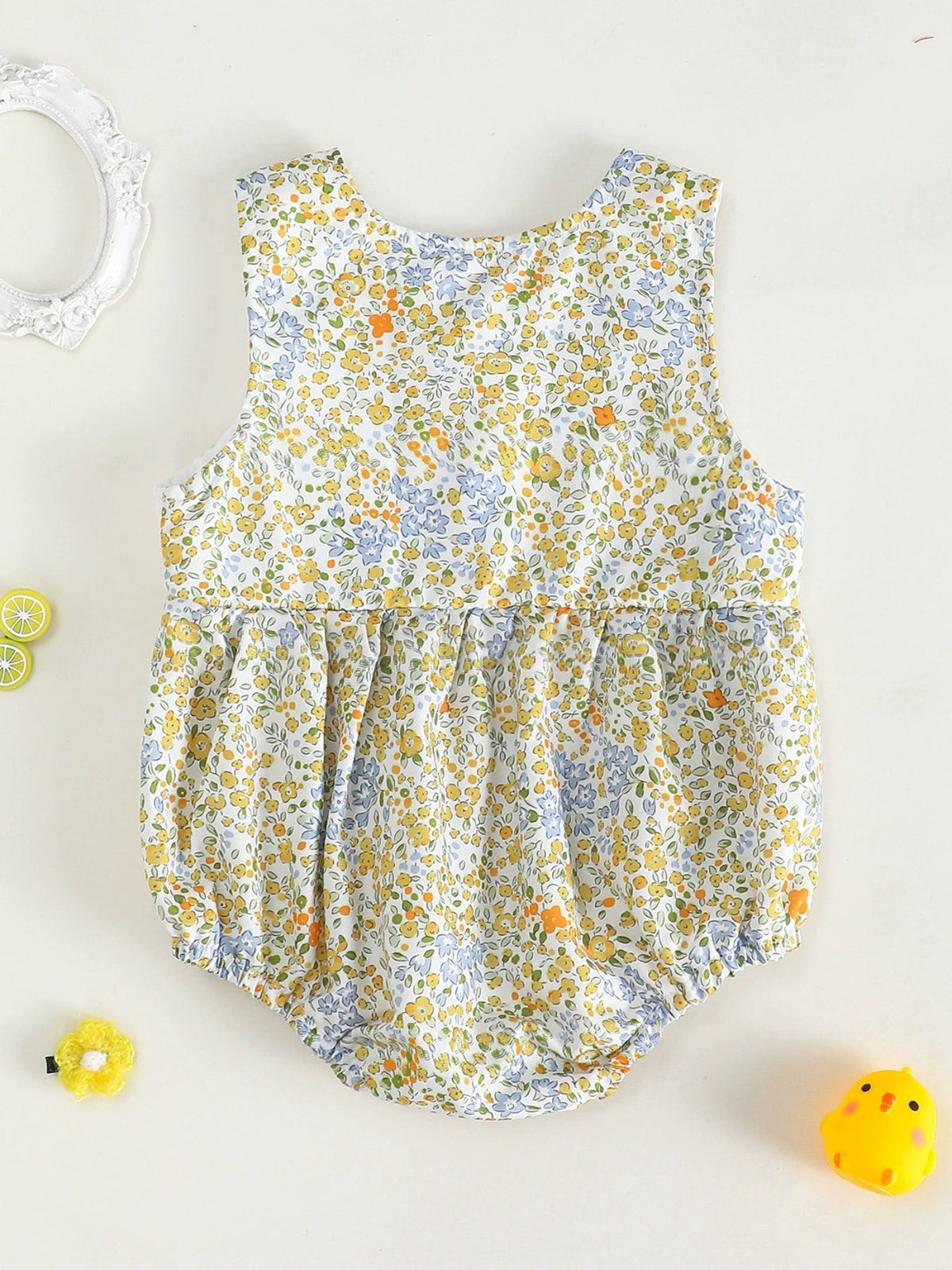 Baby girls' sleeveless bubble romper with a yellow, blue, and orange floral print.