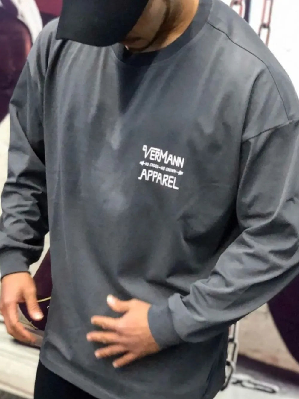Oversized dark gray long sleeve graphic tee with white Vermann Apparel logo on chest.