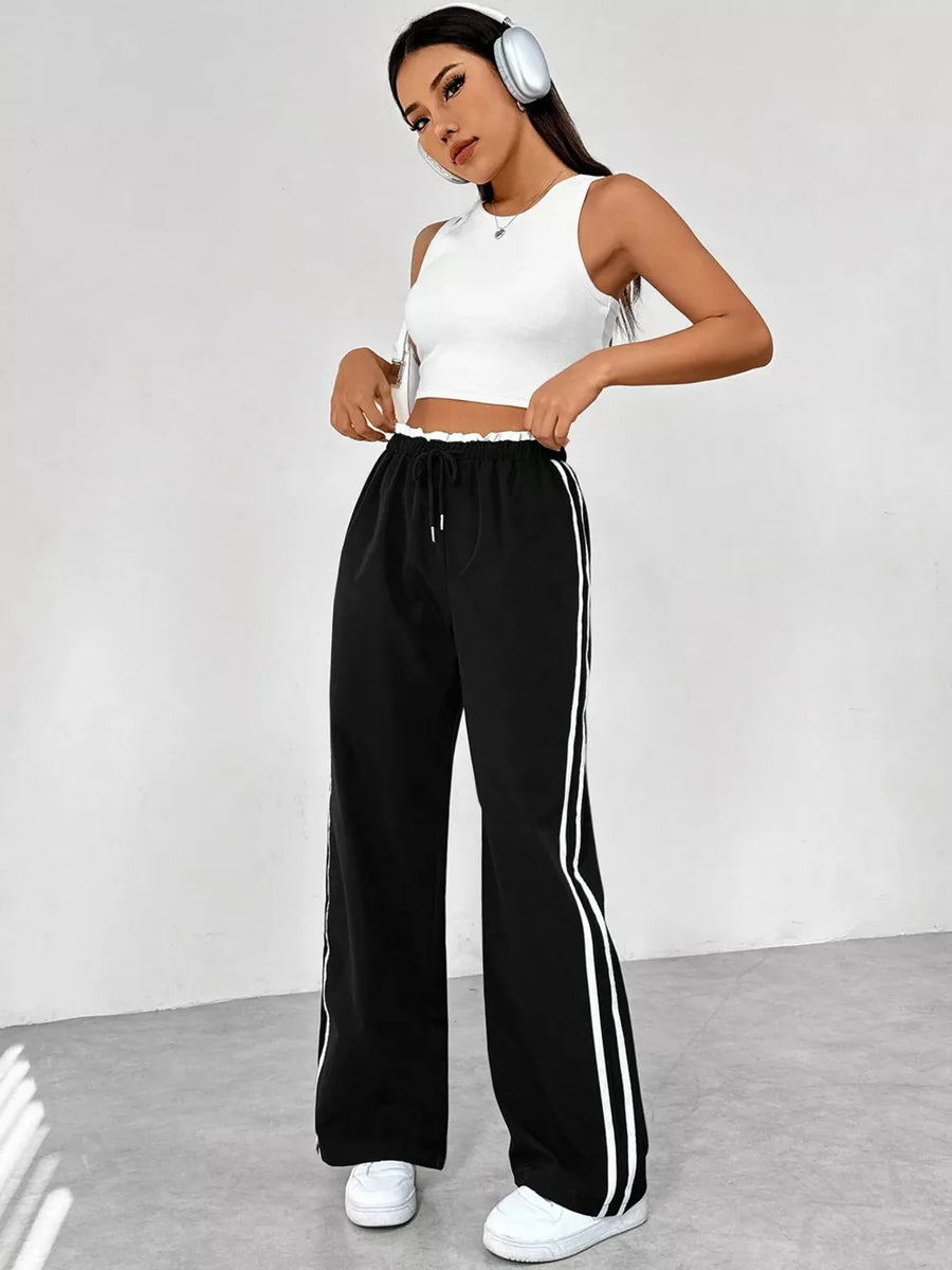 Chic black wide leg maternity pants with drawstring and white side stripes.