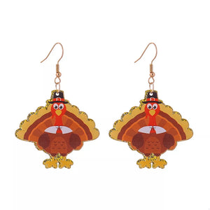 Festive turkey dangle earrings with pilgrim hats and glitter accents.