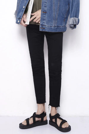 Men's black skinny jeans with raw hem detail