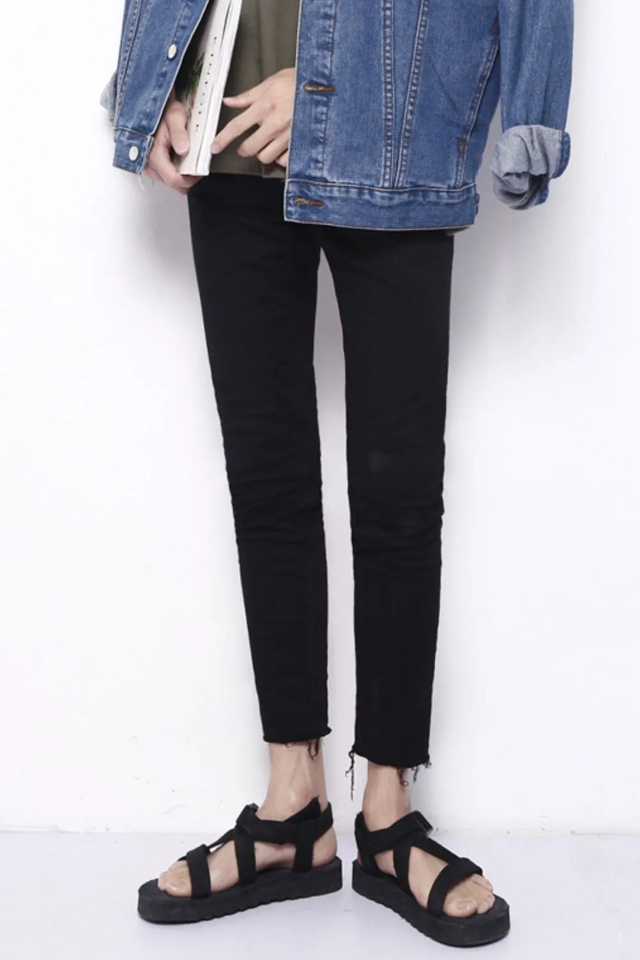 Men's black skinny jeans with raw hem detail