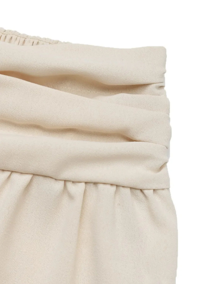 Cream ruched waistline balloon trousers with elasticated waistband detail.
