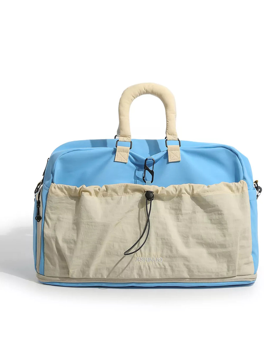 Blue crinkled nylon travel bag with drawstring pouch and padded handles.