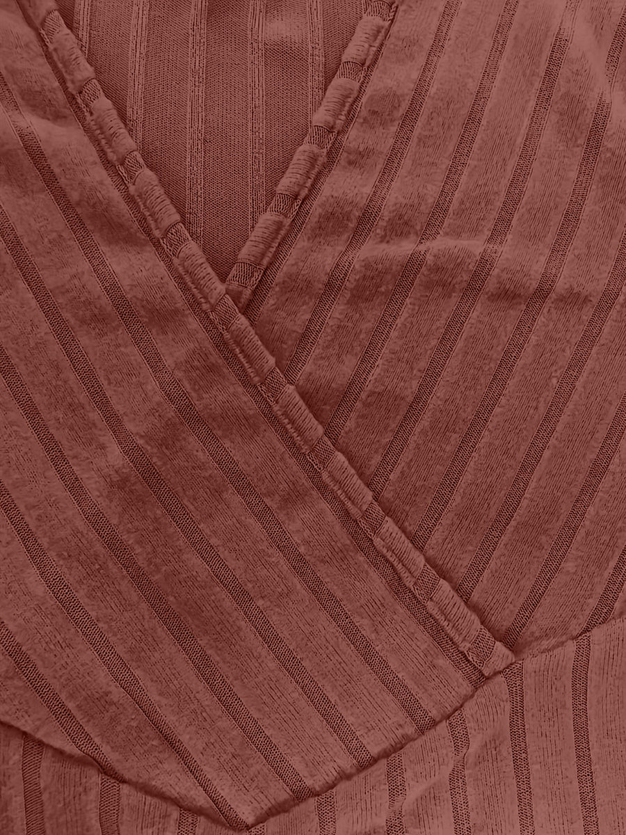 Ribbed wrap top in rust with a plunging neckline and vertical stripe texture.