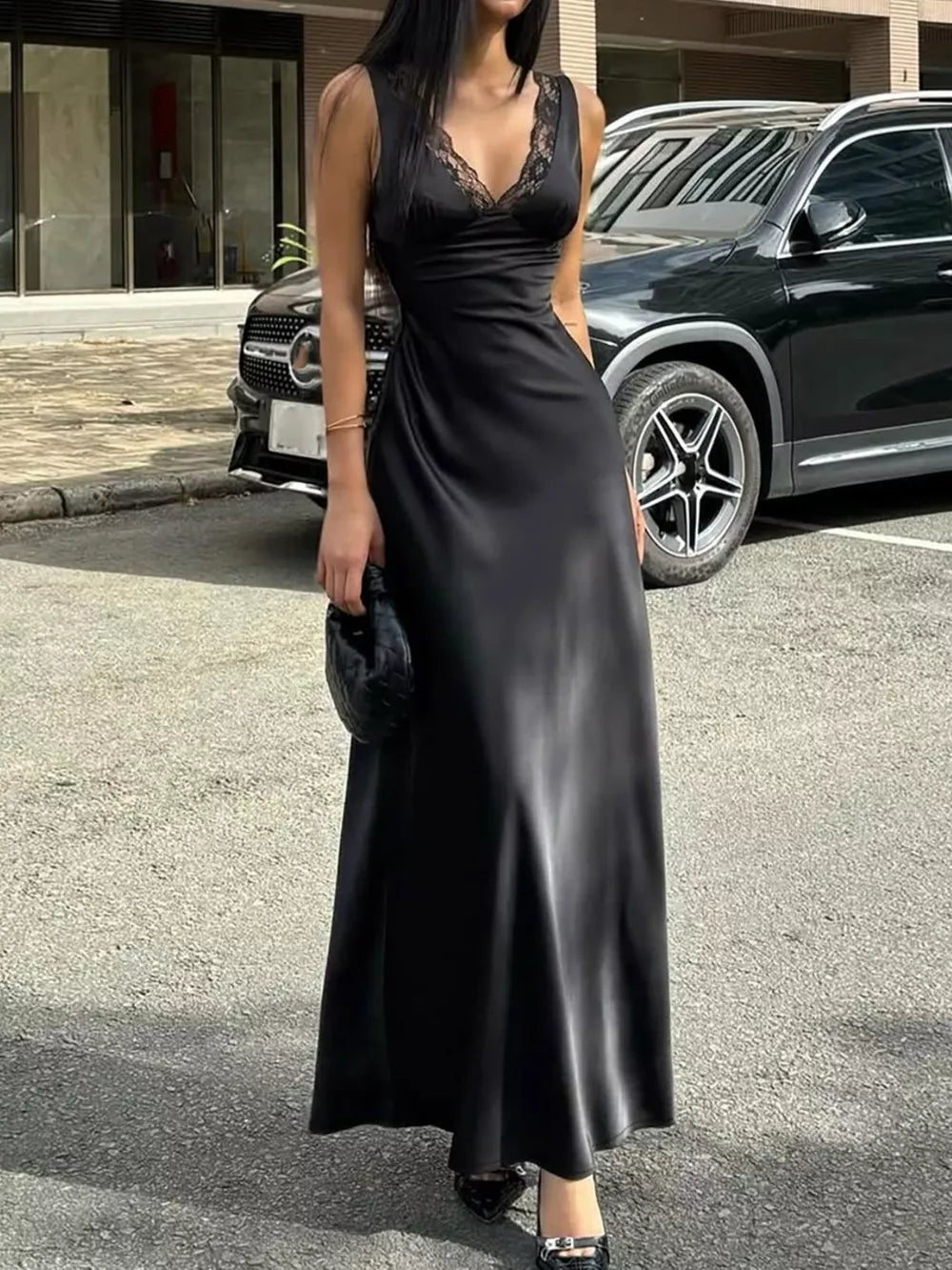 Black lace-trimmed sleeveless maxi gown with a cinched waist and V-neck.