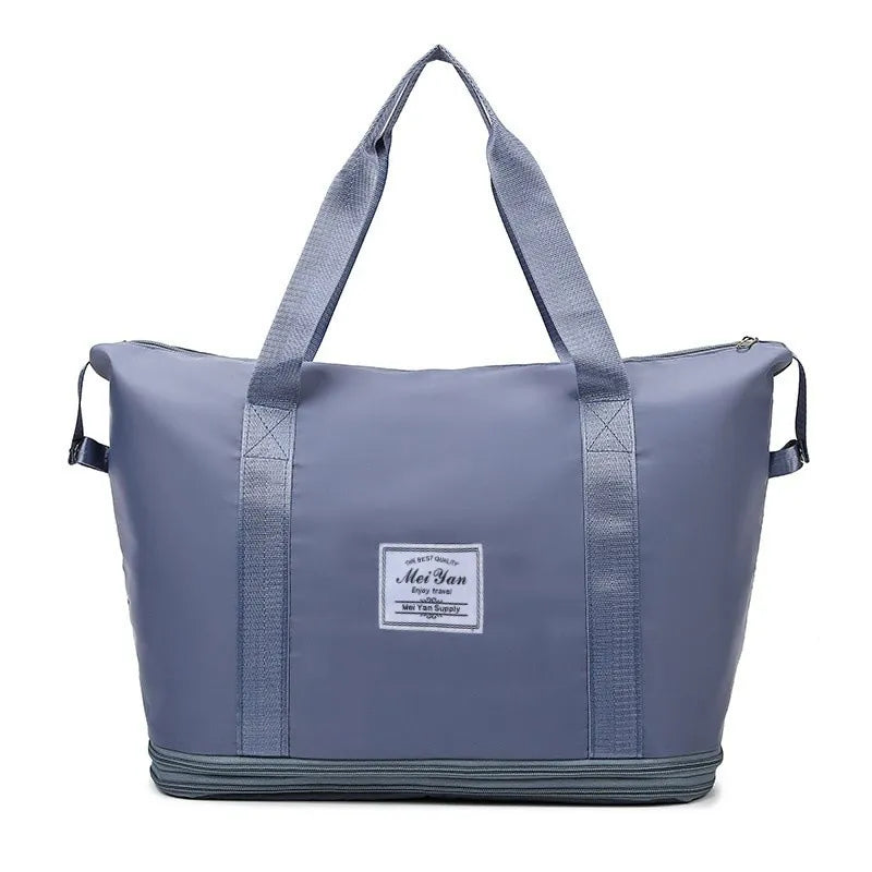 Dusty Blue expandable travel tote bag with contrast trim and dual handles.
