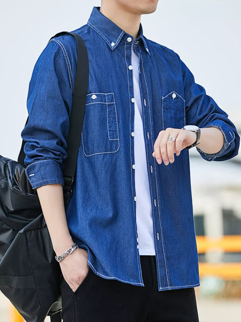 Dark blue 100% cotton denim shirt with dual chest pockets and contrast stitching.