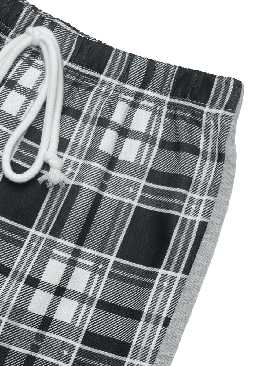 Plaid wide-leg track pants in black with white and grey plaid pattern and grey side stripe.